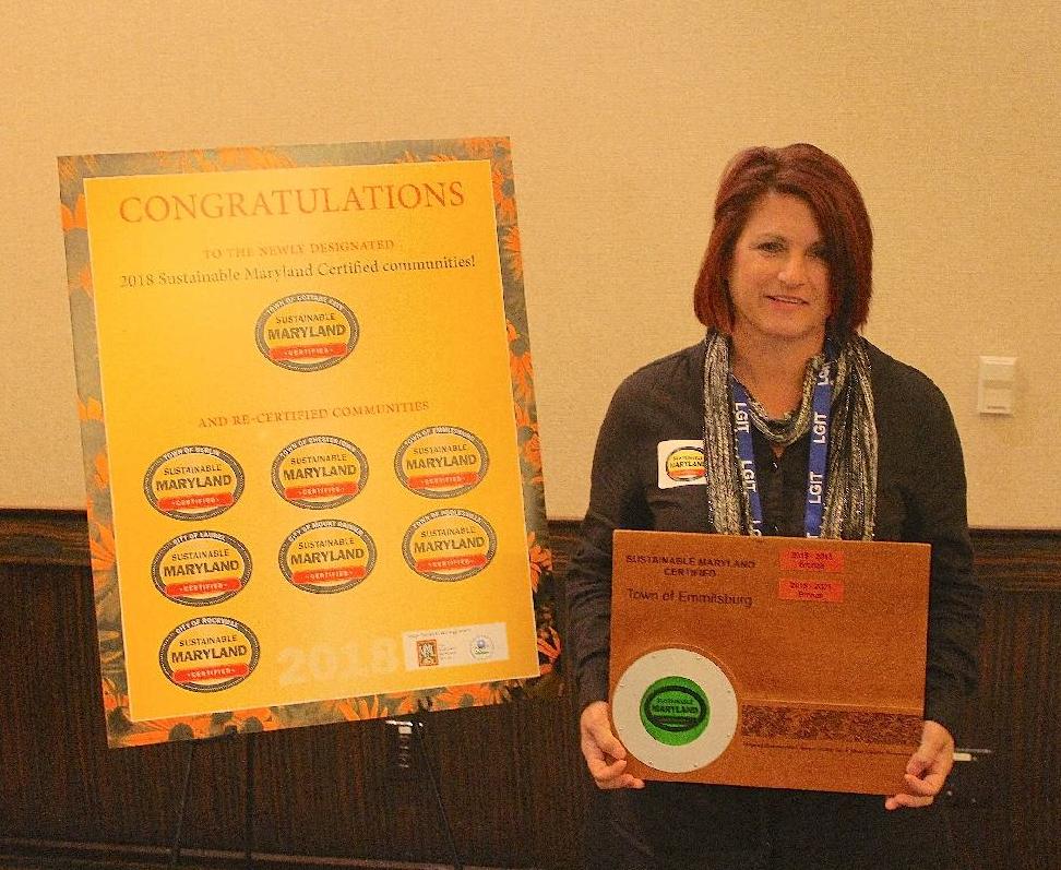 Town Manager Cathy Willets holding Emmitsburg Sustainable MD Award 2018